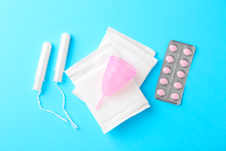 Flat lay composition with menstrual products on light blue backgroundの写真素材