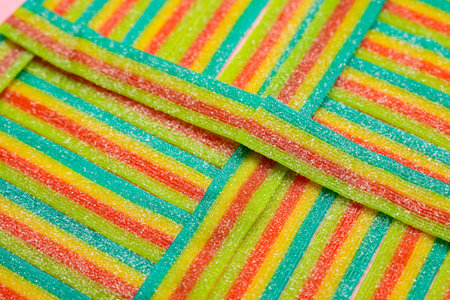 Tasty rainbow sour belts as background, closeup