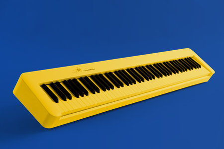 Yellow synthesizer on blue background. electronic musical instrumentの写真素材