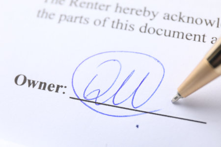 Signature and pen on paperwork, closeup view