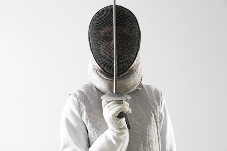Fencer with epee on white background. Combat sportの写真素材