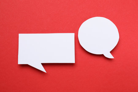 Blank speech bubbles on red background. Space for textの写真素材
