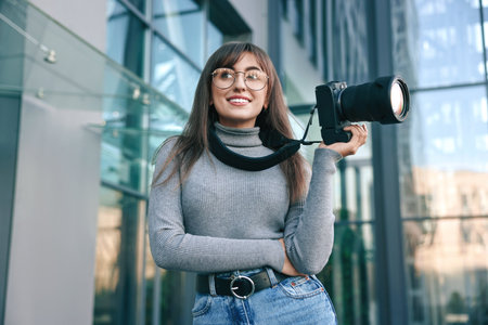 Professional photographer with digital camera near building outdoors