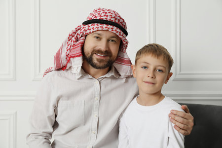 Muslim man and his son spending time together at homeの写真素材