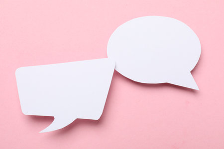 Blank speech bubbles on light pink background. Space for textの写真素材