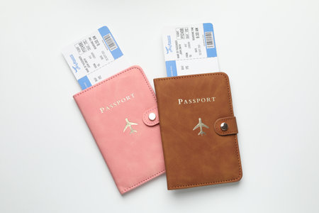Travel agency. Flight tickets and passports on light background, top viewの写真素材