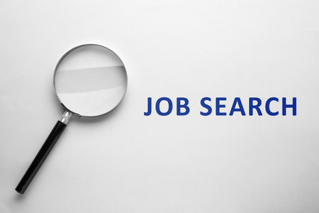 Job Search words and magnifying glass on white background, top viewの写真素材