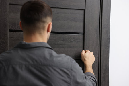 Man knocking on door to his friends apartmentの写真素材