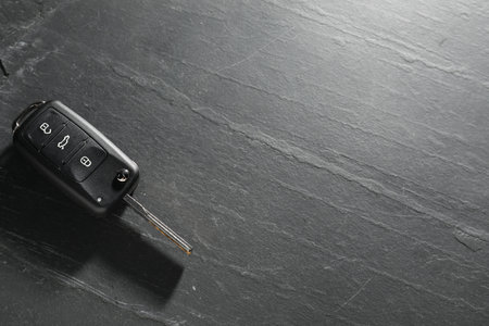 Car key on gray background, closeup with space for text.の写真素材