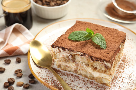 Piece of tasty tiramisu on beige table, closeupの写真素材