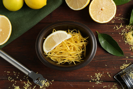 Lemon zest, tools and fresh fruits on wooden table, flat layの写真素材