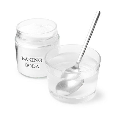 Glass of water and baking soda on white backgroundの写真素材