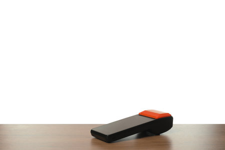 Payment terminal on wooden table against white backgroundの写真素材