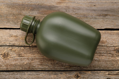 Green plastic canteen on wooden table, top viewの写真素材