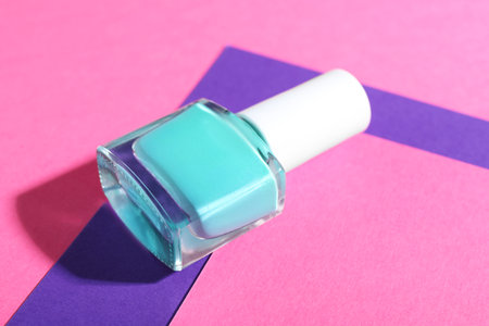 Nail polish in bottle on color background, closeupの写真素材