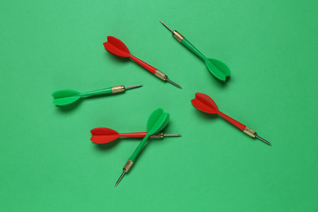 Colorful dart arrows on green background, flat layの写真素材