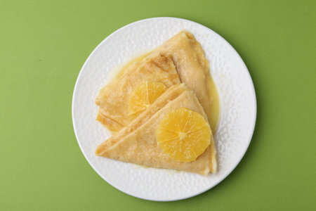Delicious Crepes Suzette on green background, top viewの写真素材