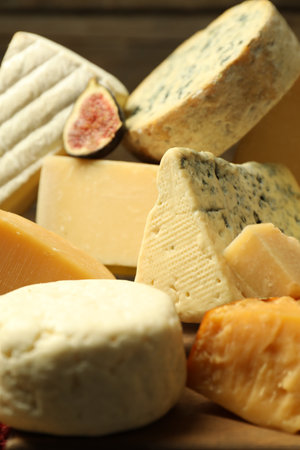 Different types of cheese and fig on table, closeup