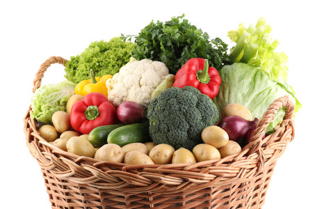 Different fresh vegetables in wicker basket isolated on whiteの写真素材