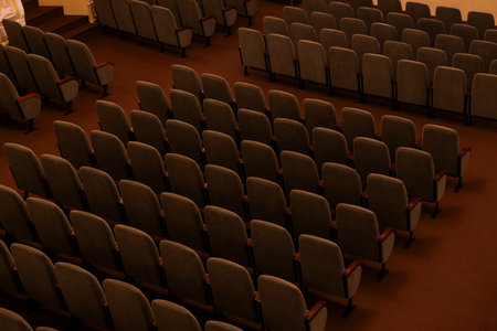 Rows of gray comfortable seats in theater
