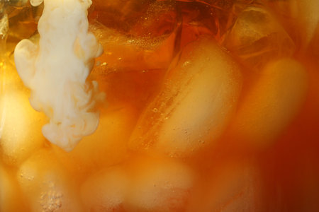 Refreshing coffee with ice and milk as background, closeupの写真素材