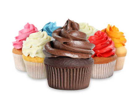 Delicious cupcakes with colorful cream isolated on whiteの写真素材