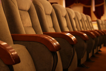 Row of gray comfortable seats in theatre, closeup