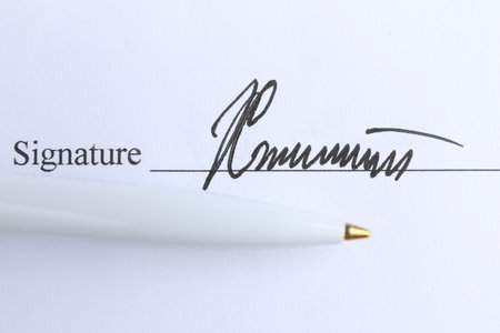 Ballpoint pen and signature on contract, top viewの写真素材