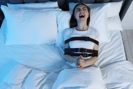 Woman in sleepwalking condition screaming in bed, above view