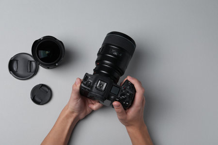 Photographer with professional camera on gray background, top viewの写真素材
