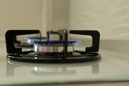 Gas burner of modern stove with burning blue flame, closeupの写真素材