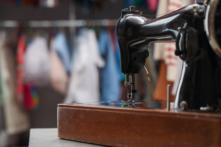 Vintage sewing machine with thread on table in workshop, space for textの写真素材