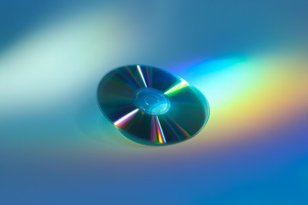One shiny compact disc on light blue backgroundの写真素材