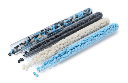 Colorful plastic granules in test tubes isolated on white