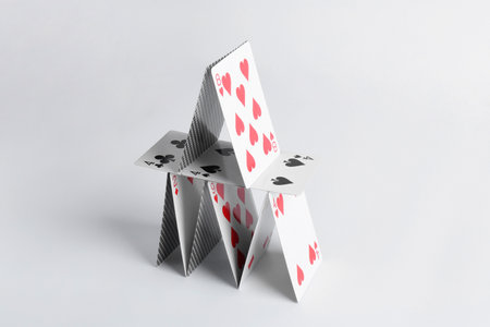 House of playing cards isolated on white