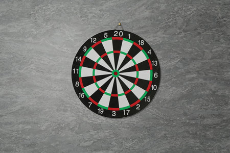 One dart board hanging on grey marble wallの写真素材