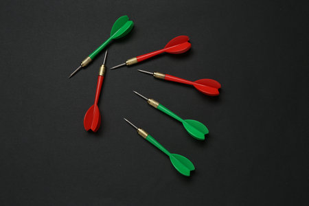 Colorful dart arrows on black background, flat layの写真素材