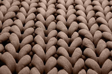 Knitted fabric in mocha mousse shade, closeup. Trendy color of 2025 year