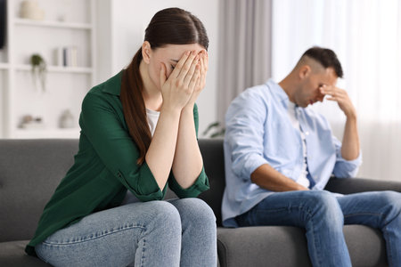 Upset woman ignoring her husband at home, selective focusの写真素材