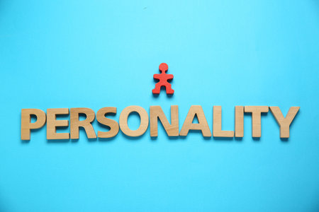 Word Personality made of wooden letters and red human figure on light blue background, top viewの写真素材