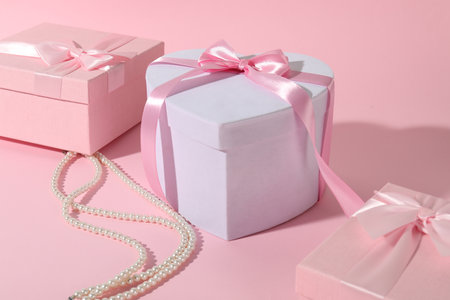 Beautiful wedding gifts and pearl jewelry on pink backgroundの写真素材