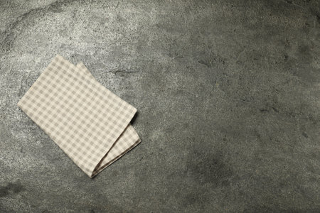 Checkered napkin on gray textured surface, top view. Space for textの写真素材