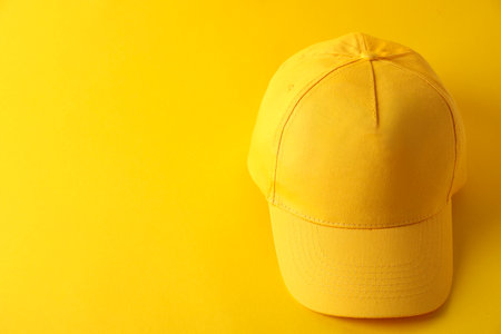 Stylish baseball cap on yellow background. Mockup for designの写真素材