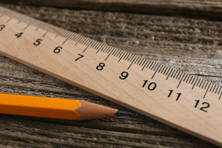 Ruler and pencil on wooden table, closeupの写真素材