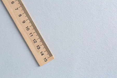 One wooden ruler on light grey background, top view. Space for textの写真素材