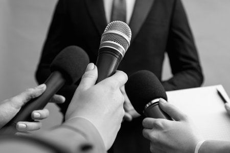 Journalists interviewing businesswoman, closeup. Toned in black-and-whiteの写真素材