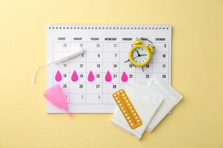Flat lay composition with calendar and menstrual products on beige backgroundの写真素材
