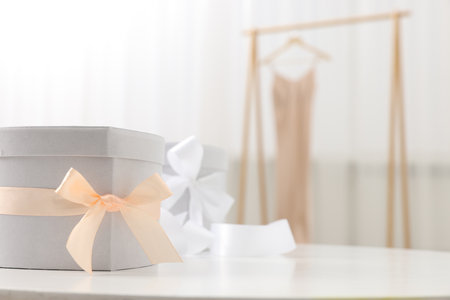 Gift boxes for wedding day on white table indoors, space for textの写真素材