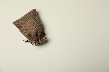 Brown burlap sack on light gray background, top view. Space for textの写真素材