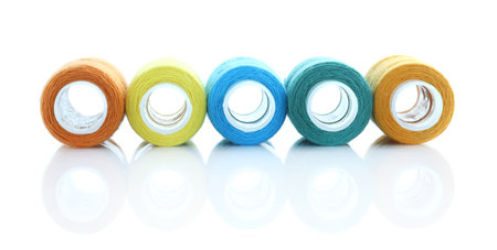 Spools of bright sewing threads isolated on white